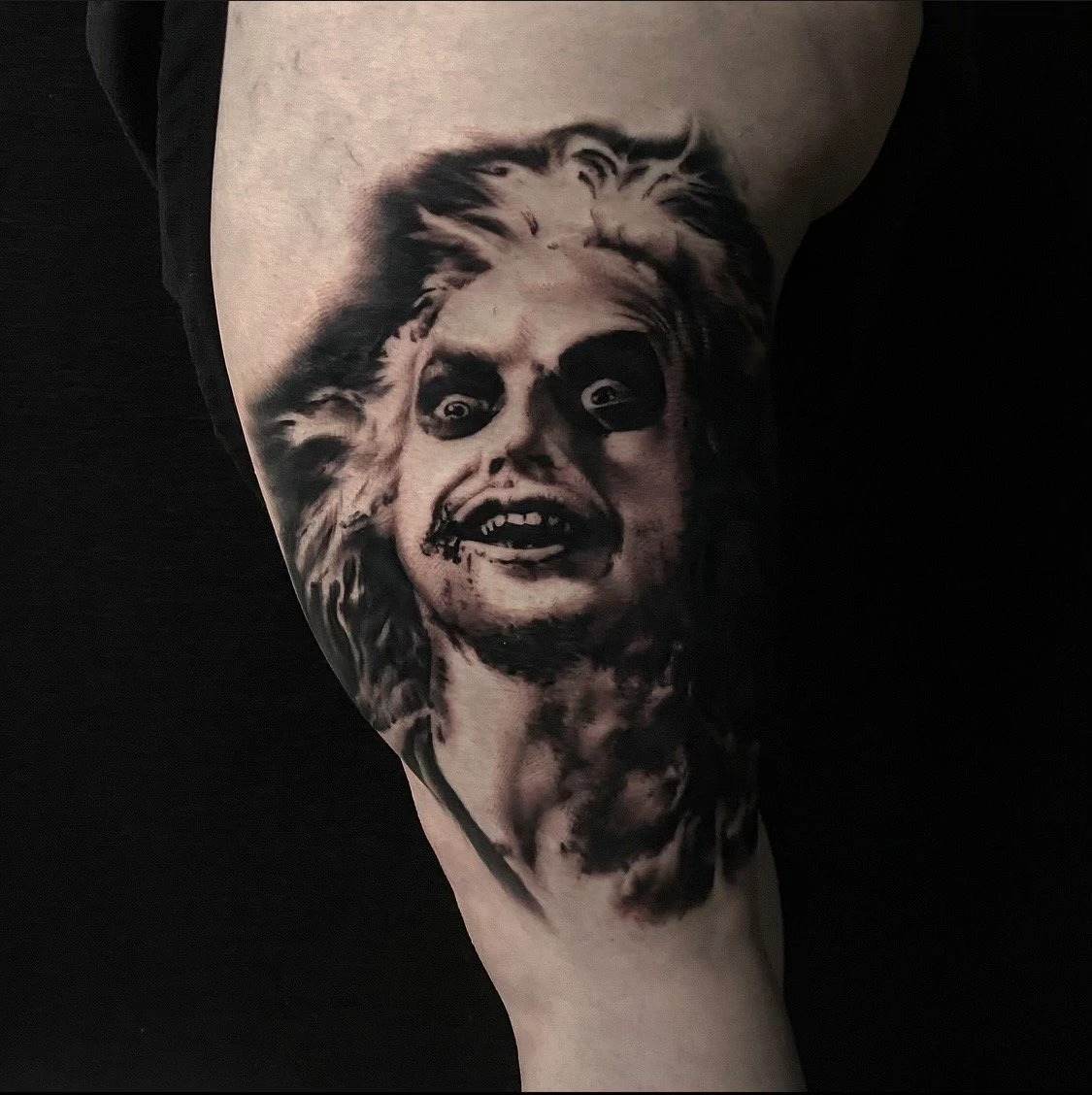 Black and grey Beetlejuice tattoo by Mike Storey