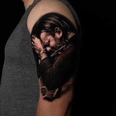 Black and grey Korn tattoo by Mike Storey