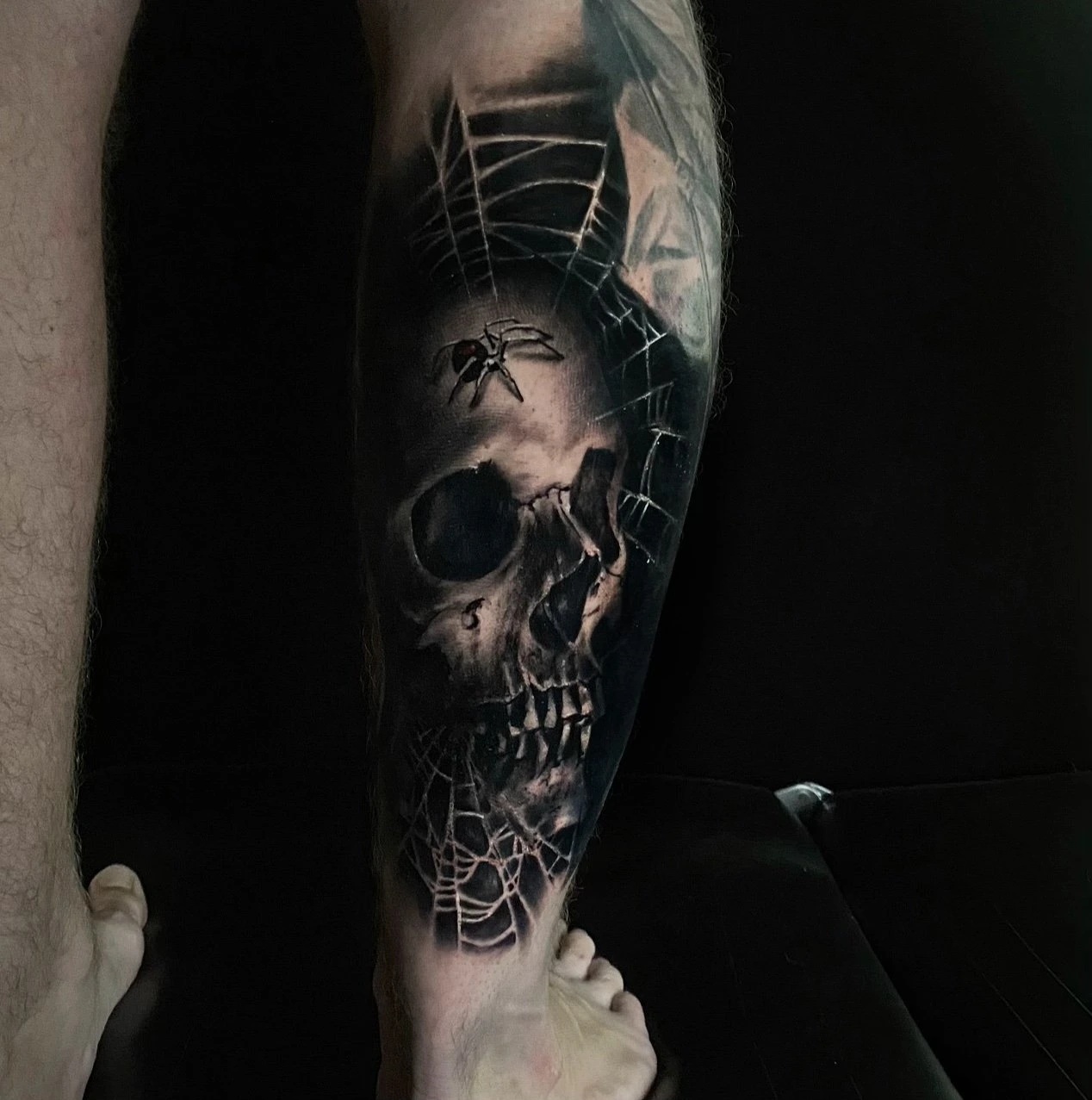 Black and grey skull tattoo by Mike Storey