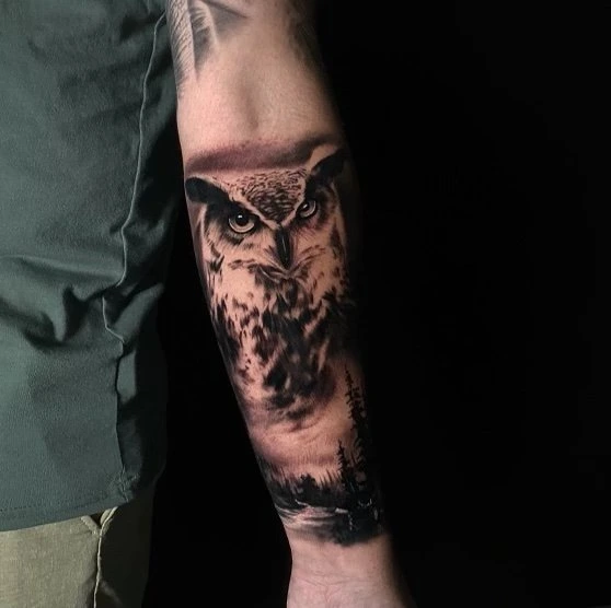 Black and grey owl tattoo by Mike Storey